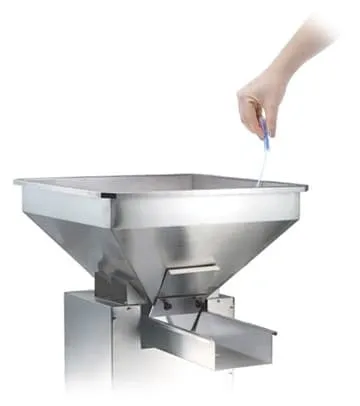 Hand using a rapid protein residue test swab on a stainless steel food processing machine part.